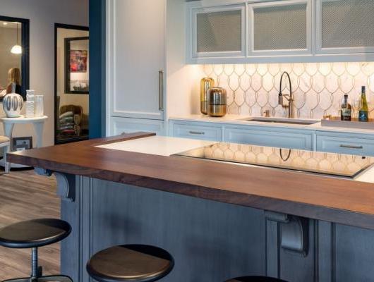 View of a sample kitchen with blue accents in Interiology design center